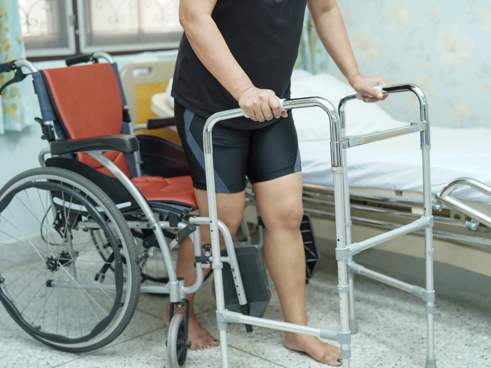 Walker, wheelchair, and hospital bed set up and ready at home